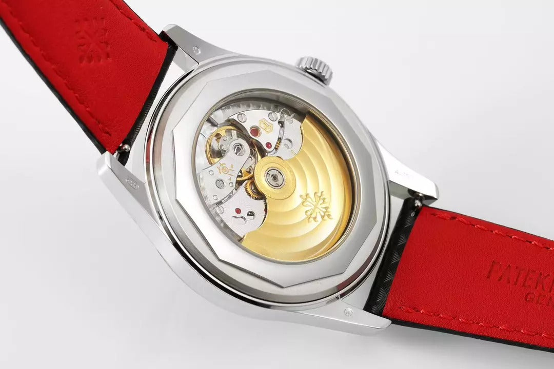 Watch with red strap and visible mechanical components on a white background