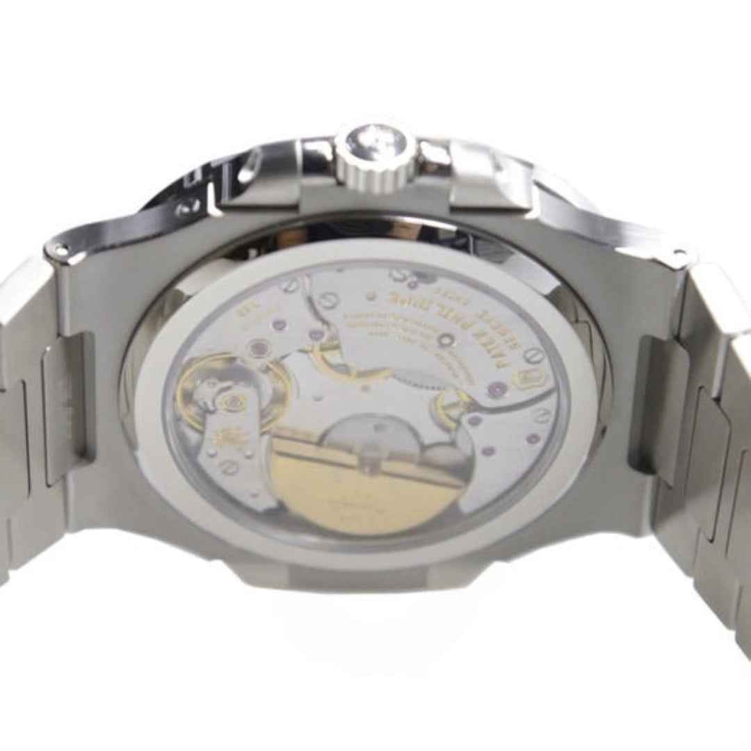 Close-up of a mechanical watch with visible movement on a white background