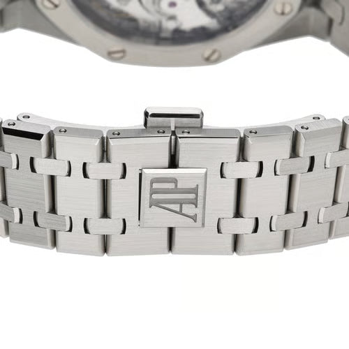 Close-up of a silver watch with a detailed metal band on a white background