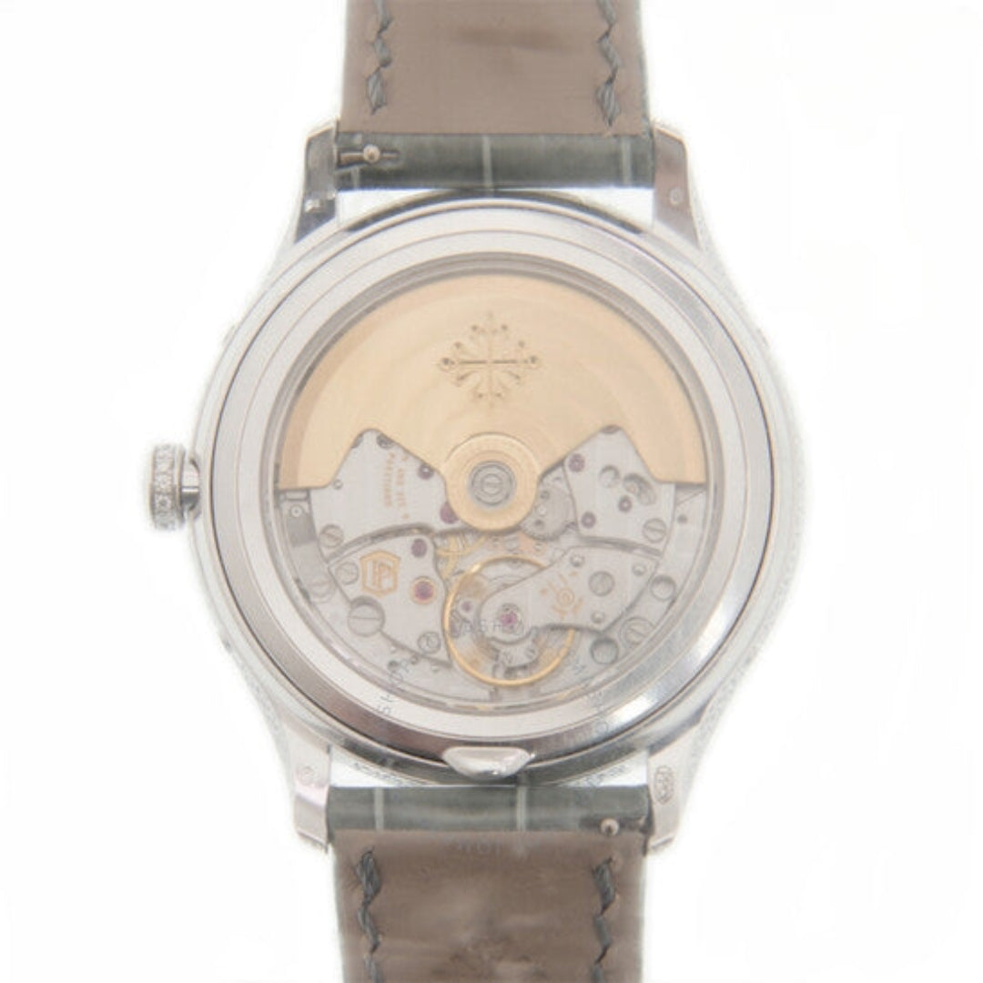 Watch with transparent caseback revealing mechanical components on a white background