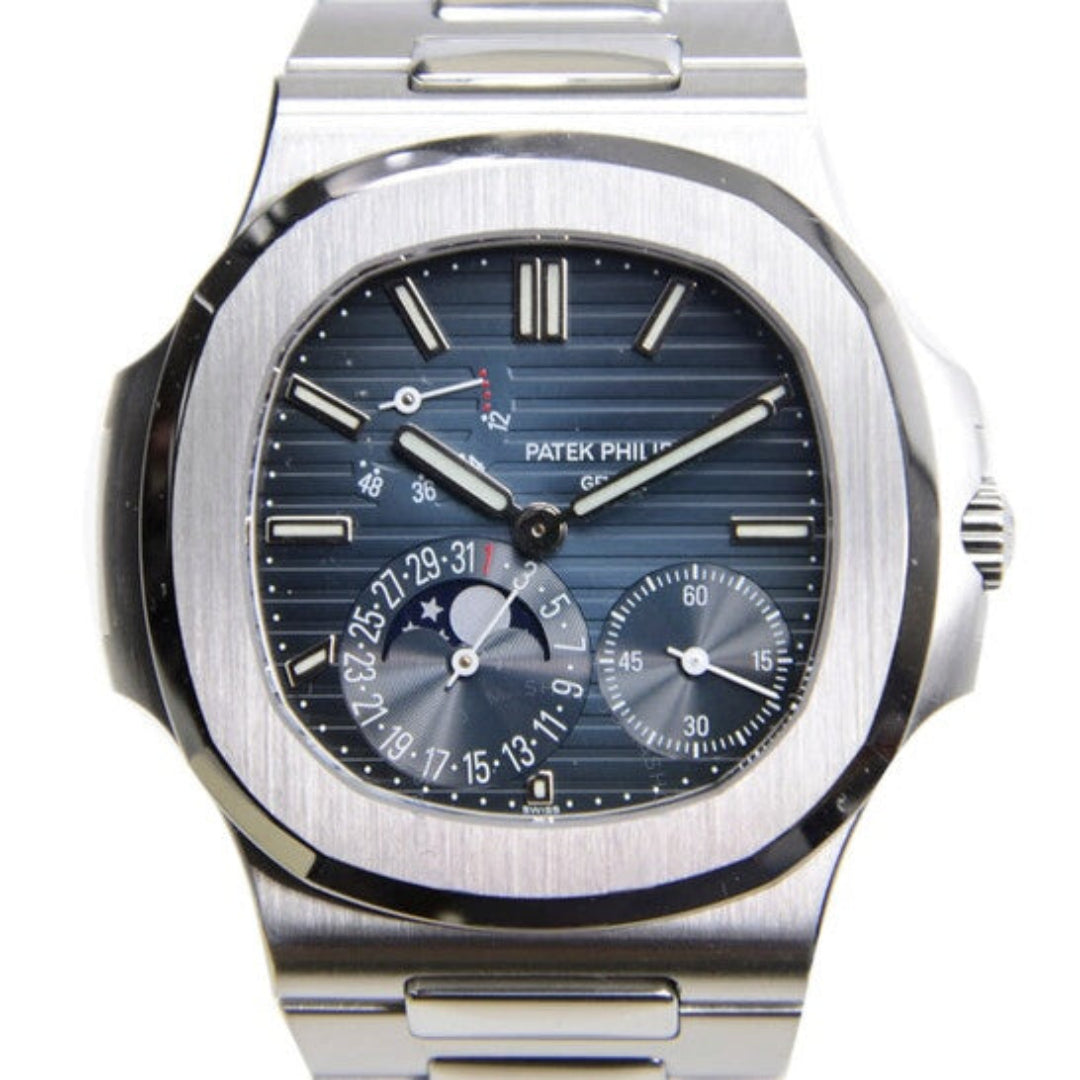 Patek Philippe watch with a blue face and silver case on a white background