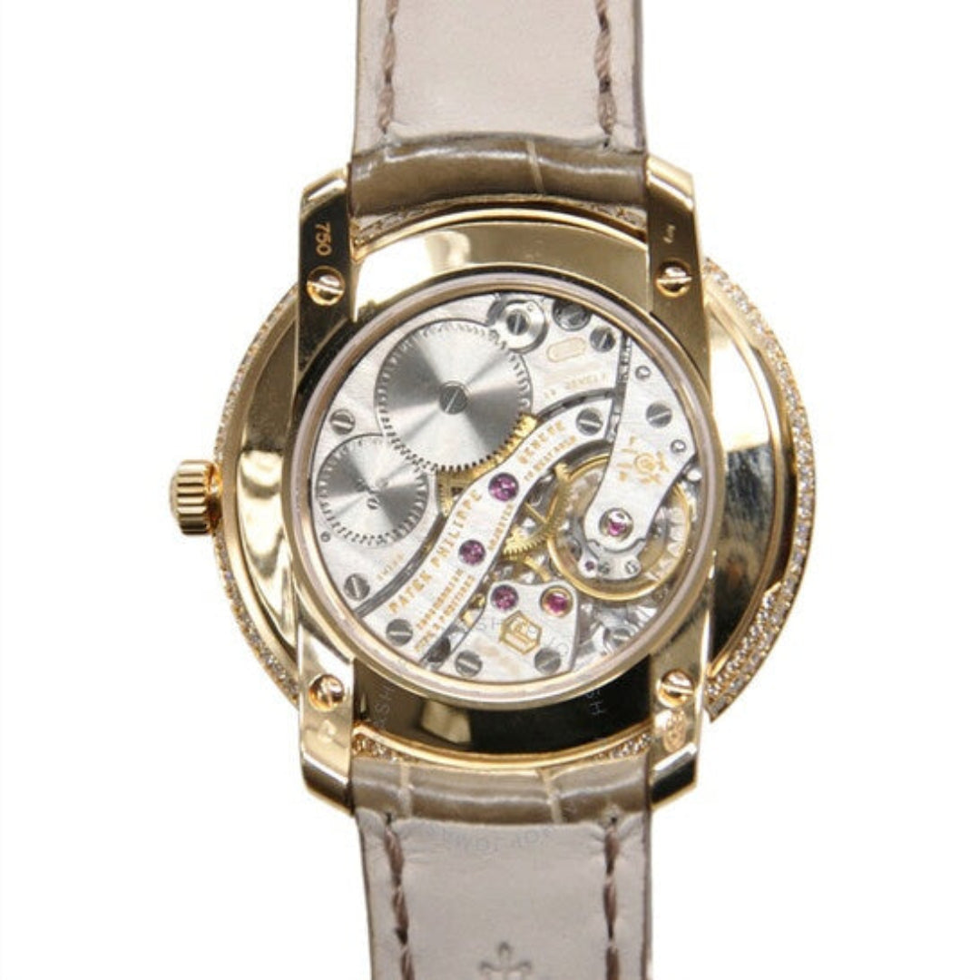 Luxury watch with gold case and white leather strap on a white background