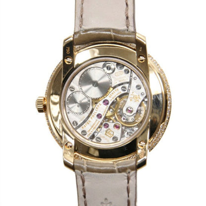 Luxury watch with gold case and white leather strap on a white background