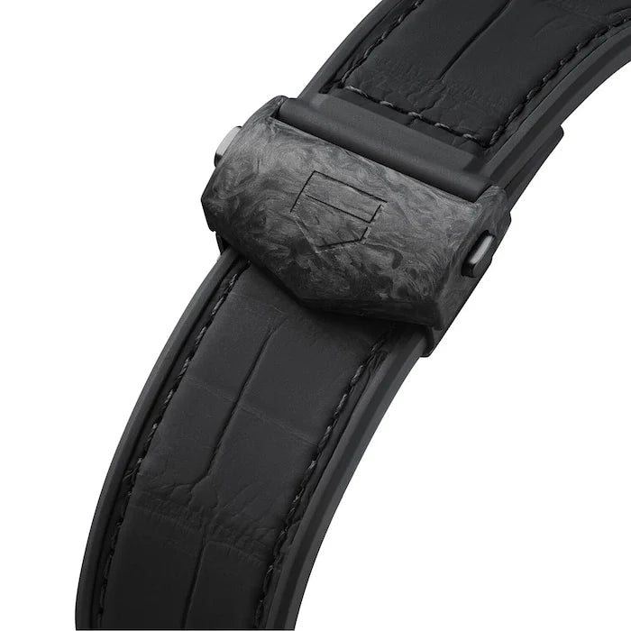 Close-up of a black leather watch strap with a buckle on a white background