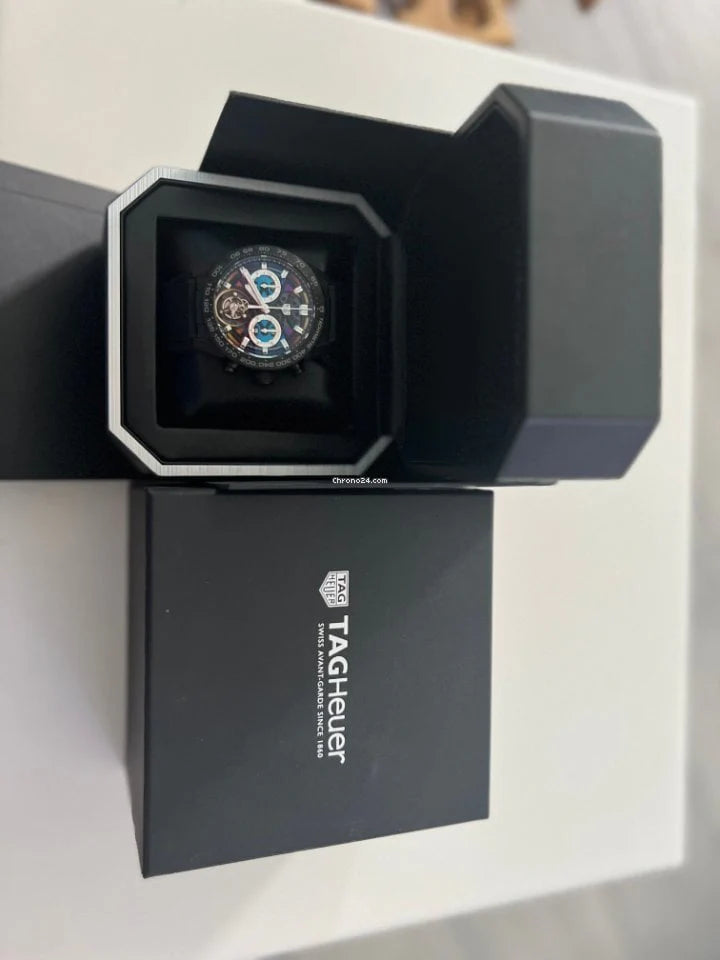 Tag Heuer watch in an open black box on a white surface