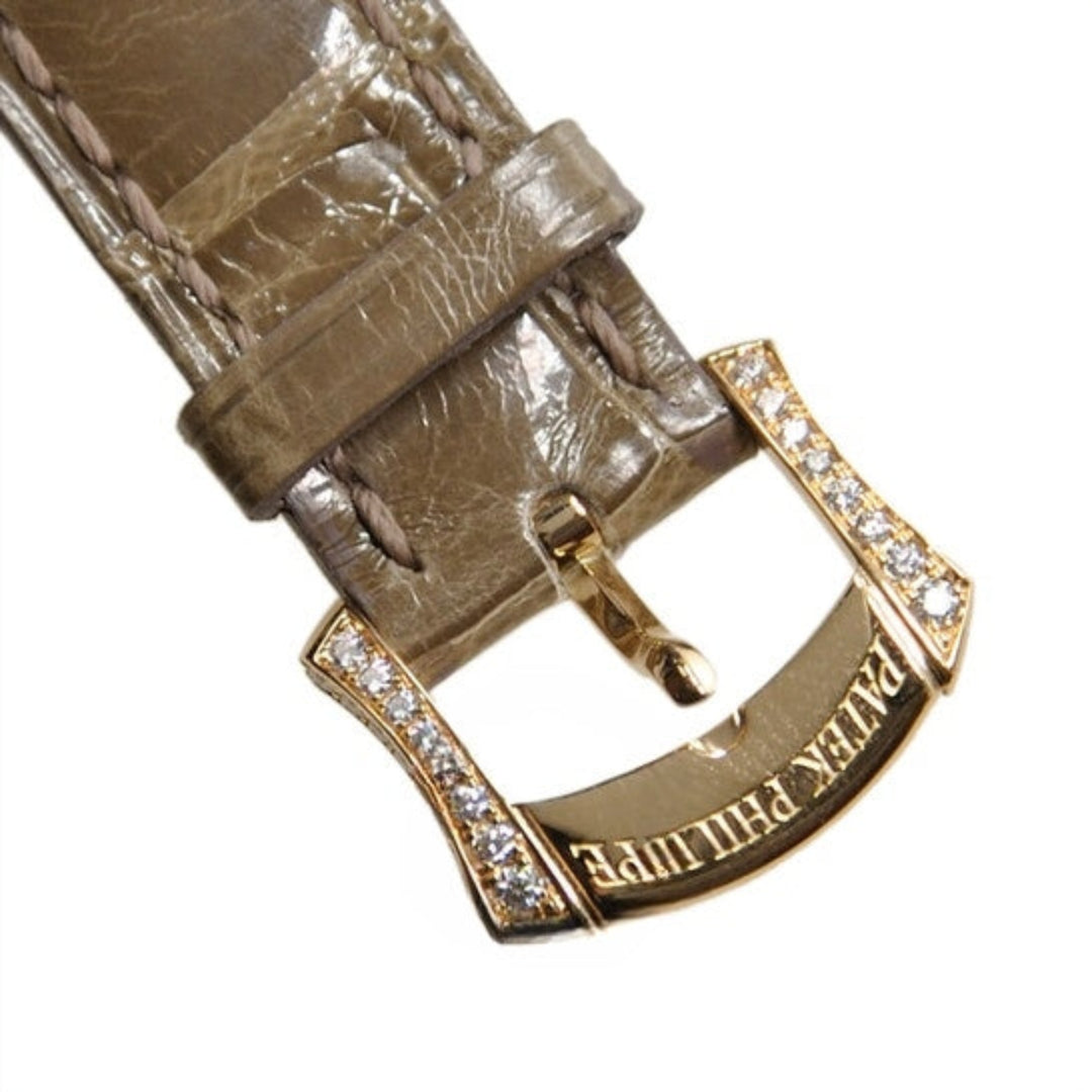 Close-up of a brown leather watch strap with a gold buckle featuring 'Bvlgari' branding on a white background.
