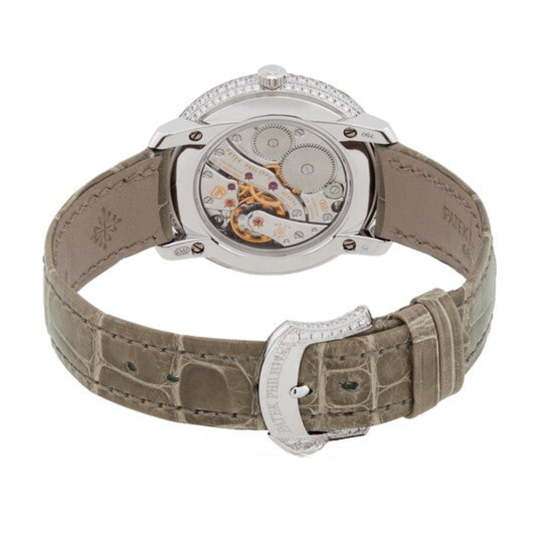 Watch with a beige strap and silver case on a white background