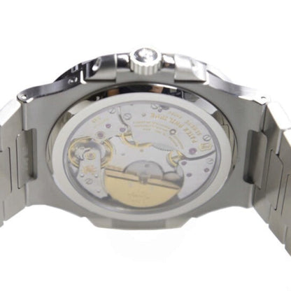 Close-up of a mechanical watch with visible movement on a white background