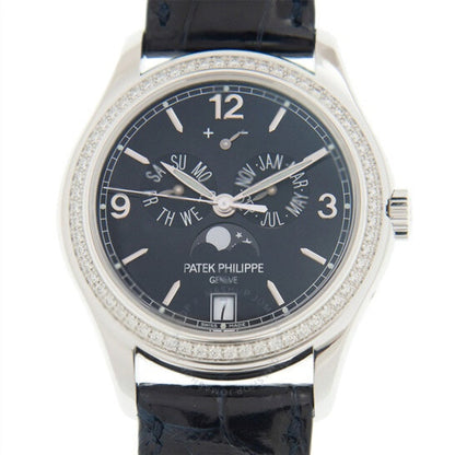 Patek Philippe watch with black dial and diamond-studded case on a white background