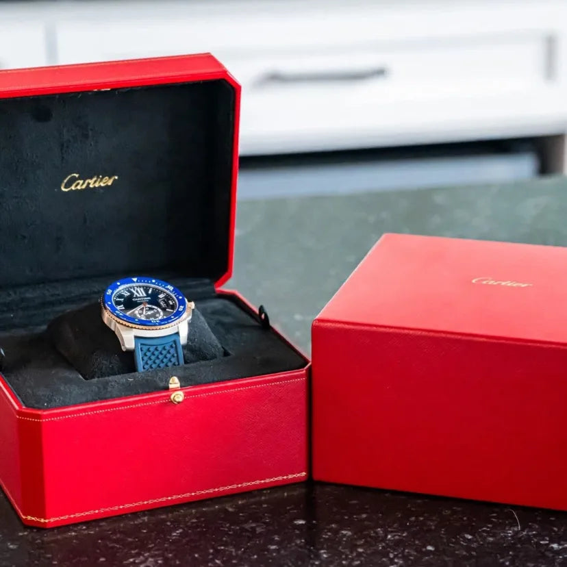 Cartier watch in a red box on a dark surface