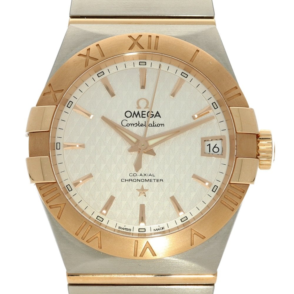 Gold and silver Omega watch with white face on a white background