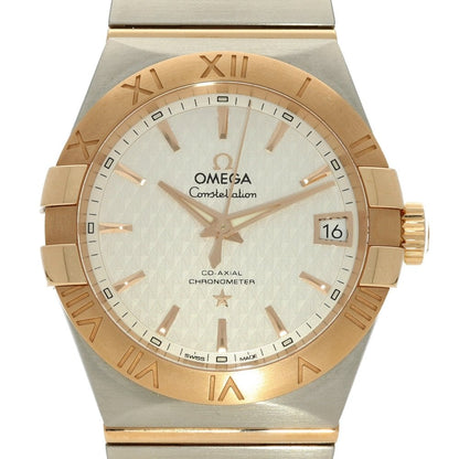 Gold and silver Omega watch with white face on a white background