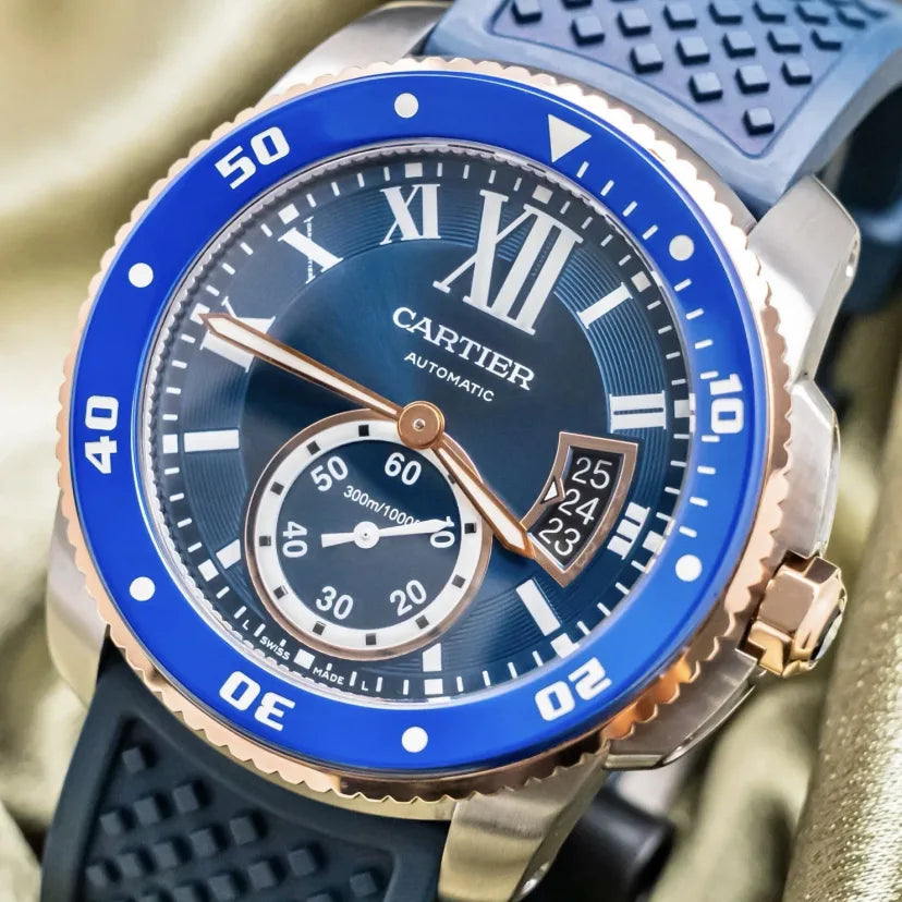 Cartier watch with blue dial and rose gold accents on a gold background