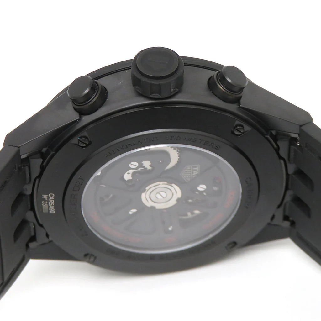 Close-up of a black watch with visible brand name on a white background