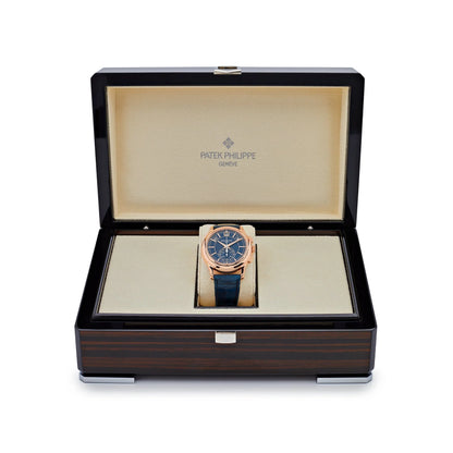 Patek Philippe watch in a wooden box on a white background