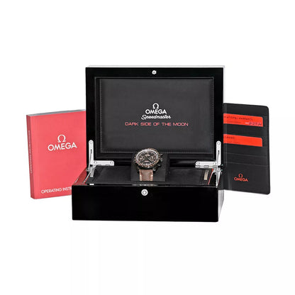 Omega watch in a black display case with red and black Omega packaging on a white background